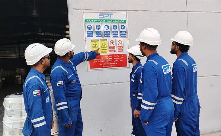 SPT HSE supervisors reviewing site safety documentation in an industrial environment